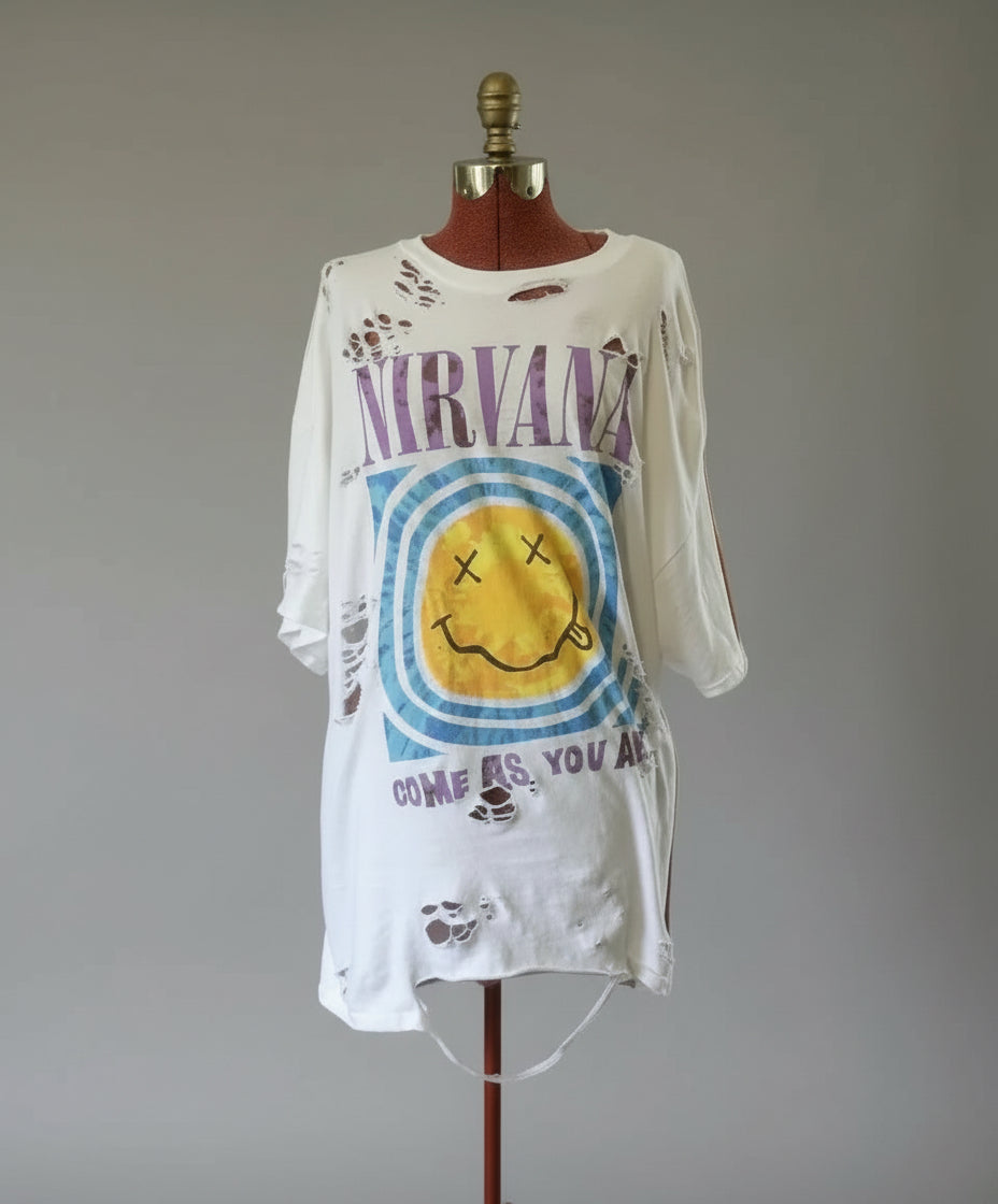 White t-shirt with colorful design on a mannequin in a room setting.